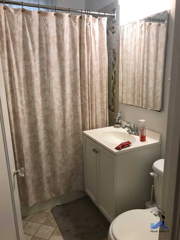 a small bathroom with a sink toilet and shower